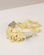 Floral tie-back headband with a flowers from fabric scraps on a white surface