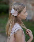 Young girl with a decorative hair clip in a natural setting